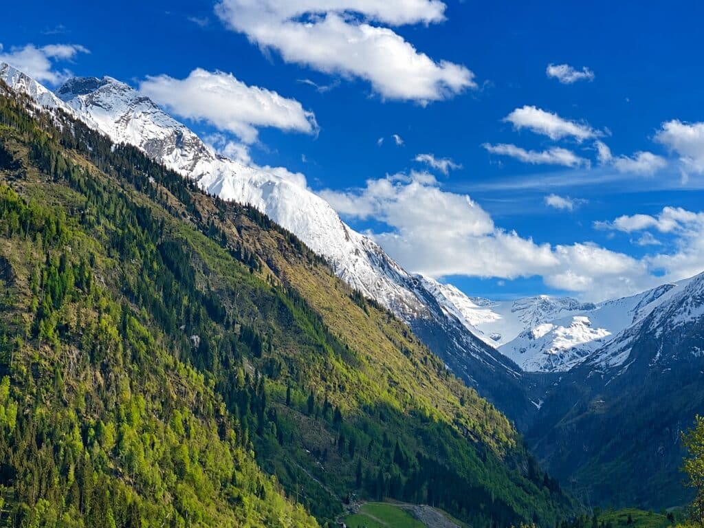 Spring contrast between lower and higher mountain tops Kaprun