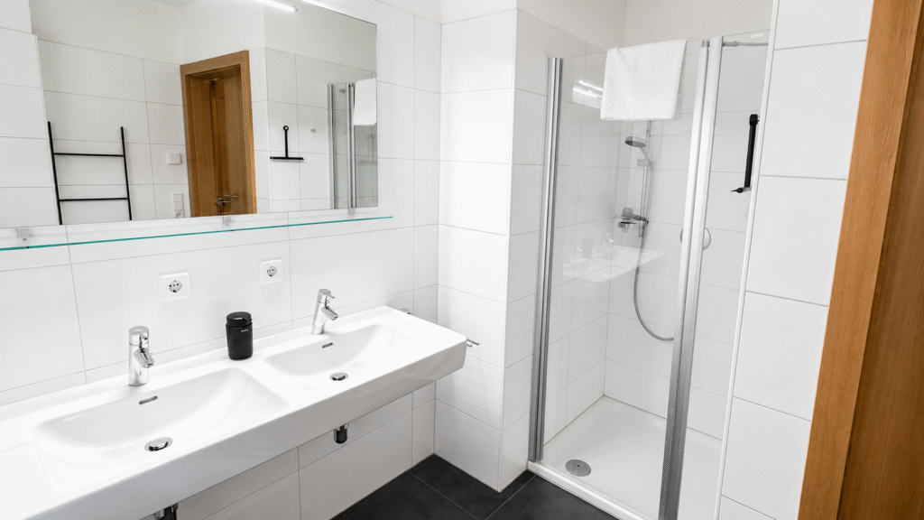 Modern bathroom with double washbasin and walk-in shower